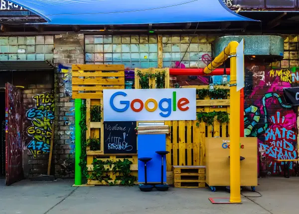 The Google logo is mounted on a colorful outdoor storefront