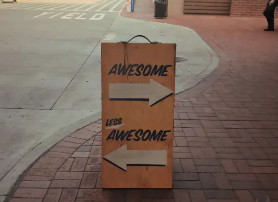 A sign features two arrows, one pointing to the awesome route and one pointing t