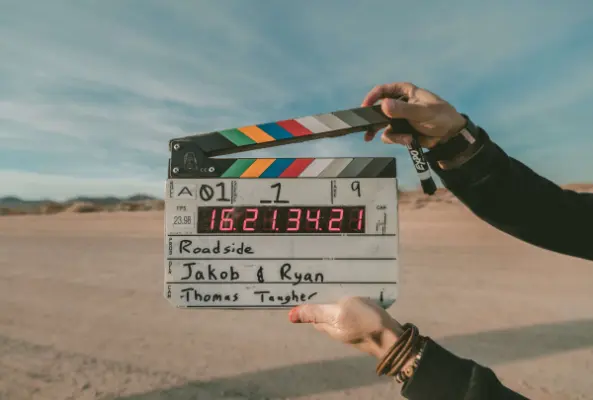 A director's board in front of a desert to mark the start of filming a B2B video