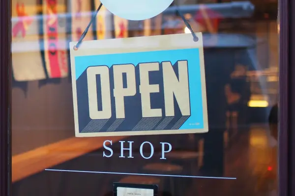 An open sign hangs on a doorway to signify your website launch