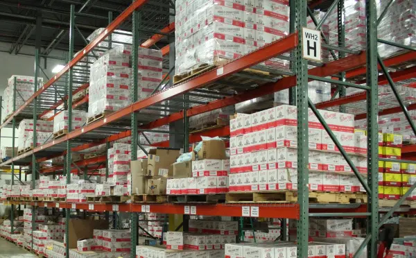 Boxes on shelves in an industrial distribution warehouse, waiting to be shipped