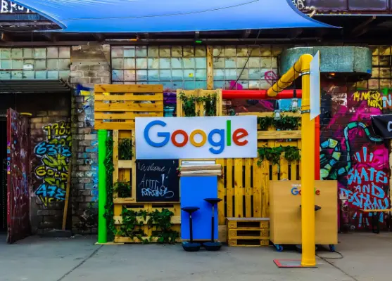 The Google logo is mounted on a colorful outdoor storefront