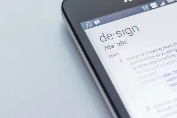 A tablet displays the word Design and provides the definition