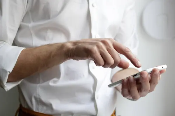 A customer interacts with an industrial B2B website on their smartphone