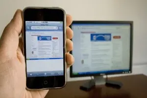 Website on desktop and on mobile phone in someone's hand