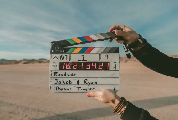 A director's board in front of a desert to mark the start of filming a B2B video