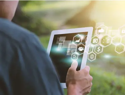 A person holds up a tablet and looks at the screen