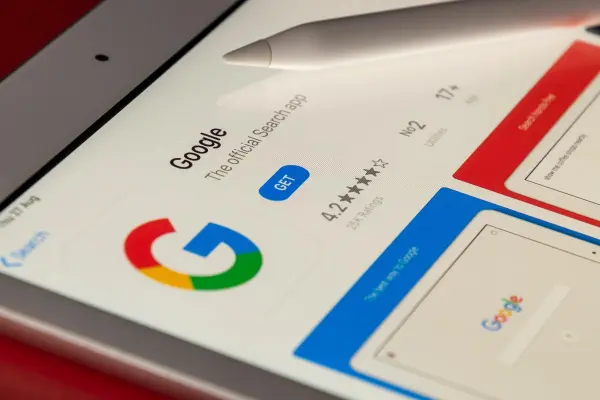 A phone displays the google app as the user prepares for the GA4 update