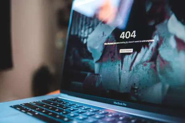 A 404 error displays on a laptop screen